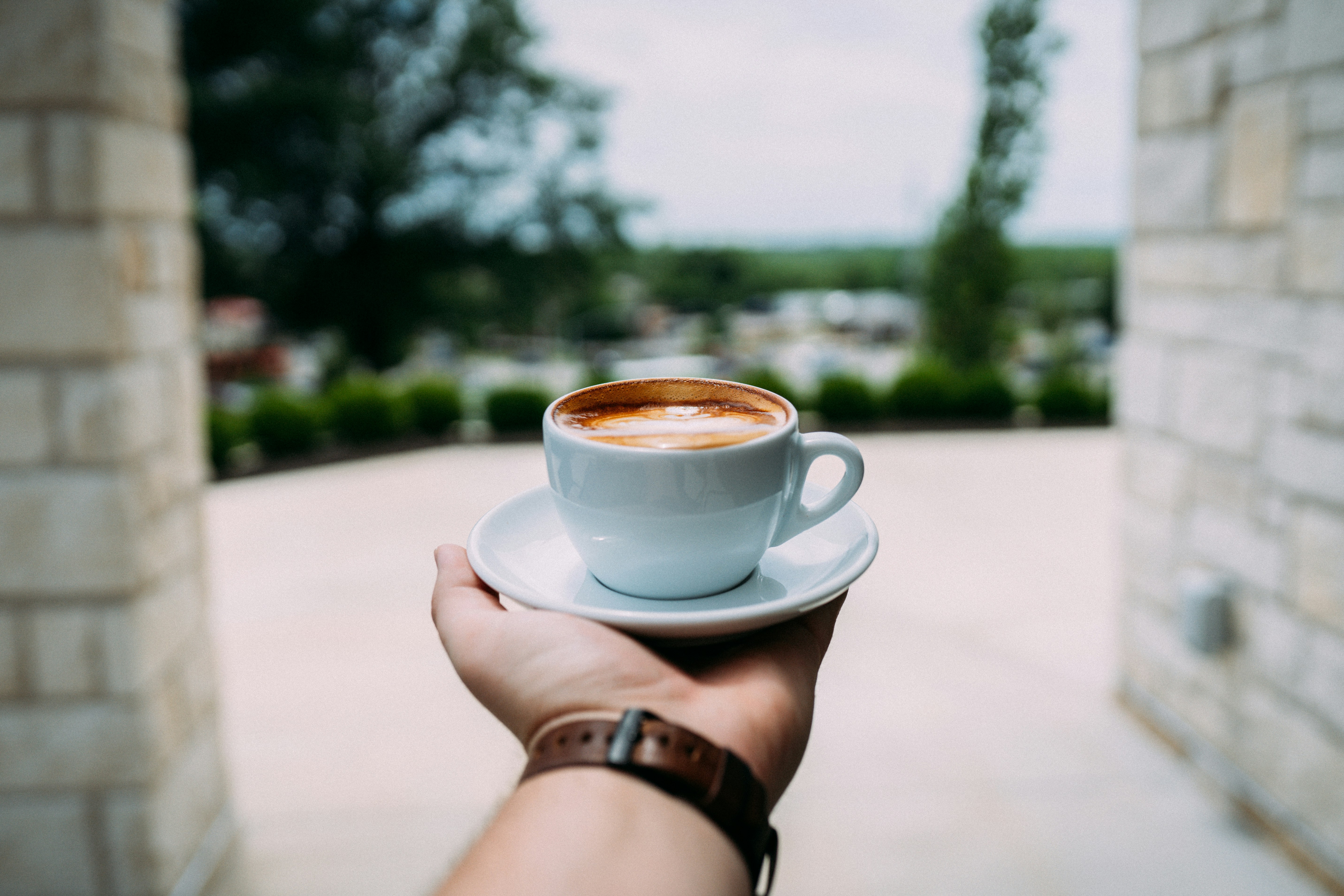 Close-up espresso extraction with warm tones